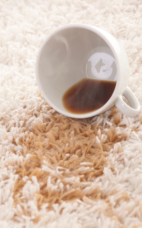 Dark coffee spill in a beige carpet, book Zerorez today to remove coffee stains.