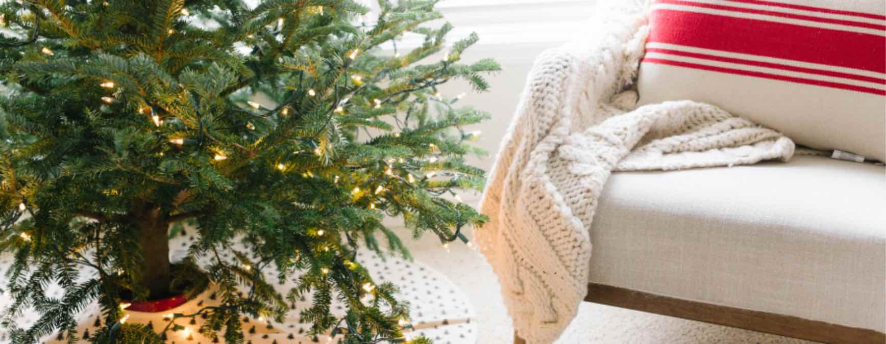 A cozy chair and blanket by the Christmas tree that is clean and welcoming thanks to Zerorez.